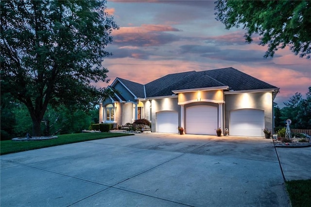3401 NE 153rd Ter, Smithville, MO 64089 - view of front of property featuring stucco siding, driveway, a garage, and roof with shingles