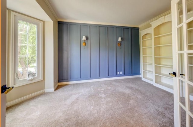 9307 W 146th St, Overland Park, KS 66221 - unfurnished room with carpet flooring, french doors, ornamental molding, and built in features