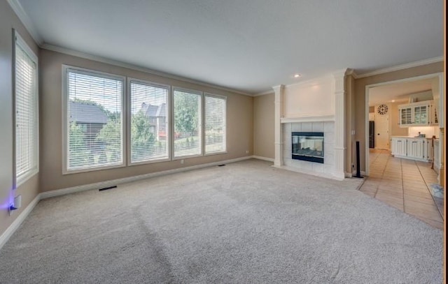9307 W 146th St, Overland Park, KS 66221 - unfurnished living room featuring ornamental molding, healthy amount of natural light, light carpet, a fireplace, and recessed lighting