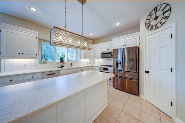 9307 W 146th St, Overland Park, KS 66221 - kitchen featuring appliances with stainless steel finishes, tasteful backsplash, light countertops, recessed lighting, and light tile patterned flooring