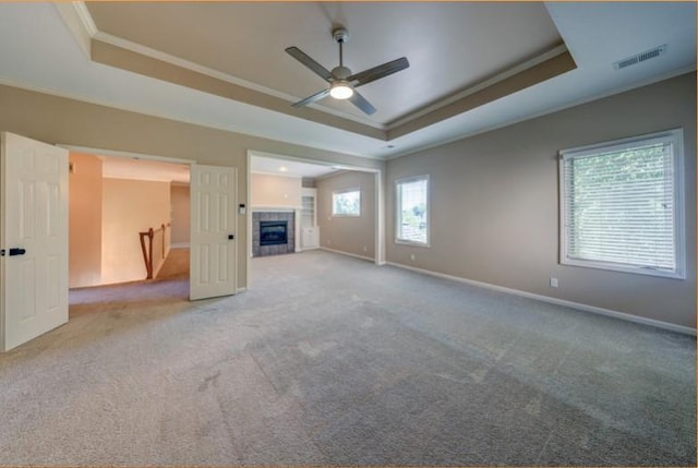 9307 W 146th St, Overland Park, KS 66221 - unfurnished living room featuring a tray ceiling, crown molding, a ceiling fan, carpet, and a fireplace