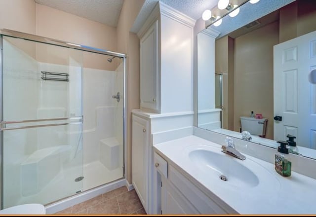 9307 W 146th St, Overland Park, KS 66221 - bathroom with a stall shower, a textured ceiling, vanity, and tile patterned flooring