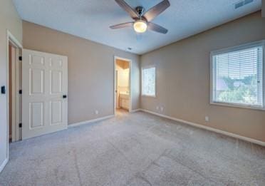 9307 W 146th St, Overland Park, KS 66221 - unfurnished bedroom with multiple windows, carpet, connected bathroom, and ceiling fan