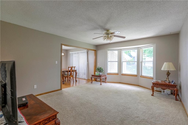 1705 N Jones Ct, Independence, MO 64056 - sitting room featuring ceiling fan, carpet, and a textured ceiling