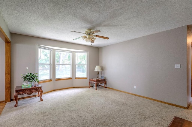 1705 N Jones Ct, Independence, MO 64056 - empty room featuring ceiling fan, light carpet, and a textured ceiling