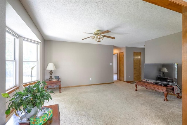 1705 N Jones Ct, Independence, MO 64056 - unfurnished living room featuring ceiling fan, carpet flooring, and a textured ceiling