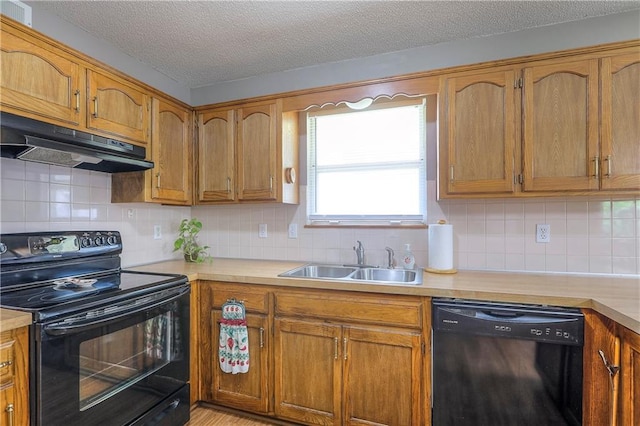 1705 N Jones Ct, Independence, MO 64056 - kitchen with black range with electric cooktop, dishwasher, under cabinet range hood, light countertops, and a textured ceiling