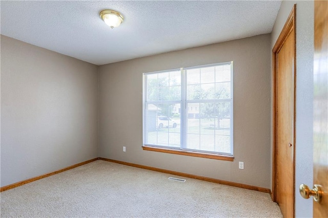 1705 N Jones Ct, Independence, MO 64056 - empty room featuring light carpet and a textured ceiling