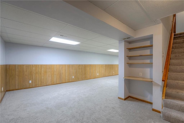 1705 N Jones Ct, Independence, MO 64056 - finished basement featuring stairway, wood walls, carpet floors, a wainscoted wall, and a paneled ceiling