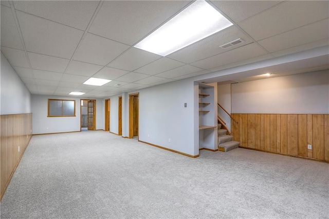 1705 N Jones Ct, Independence, MO 64056 - finished below grade area featuring stairs, carpet, a paneled ceiling, wooden walls, and wainscoting