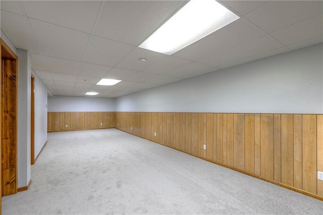 1705 N Jones Ct, Independence, MO 64056 - unfurnished room featuring carpet, a drop ceiling, wooden walls, and wainscoting