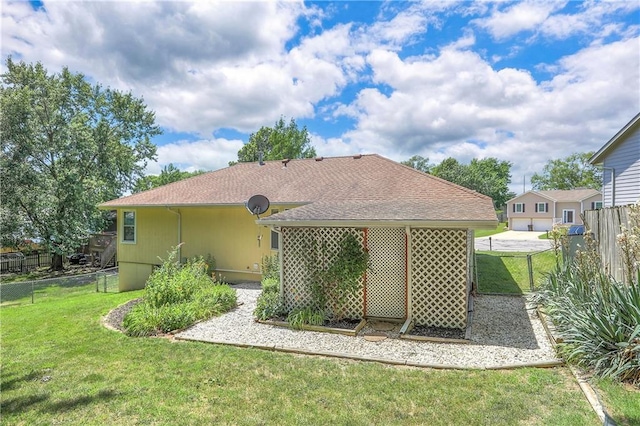 1705 N Jones Ct, Independence, MO 64056 - rear view of property featuring a shingled roof