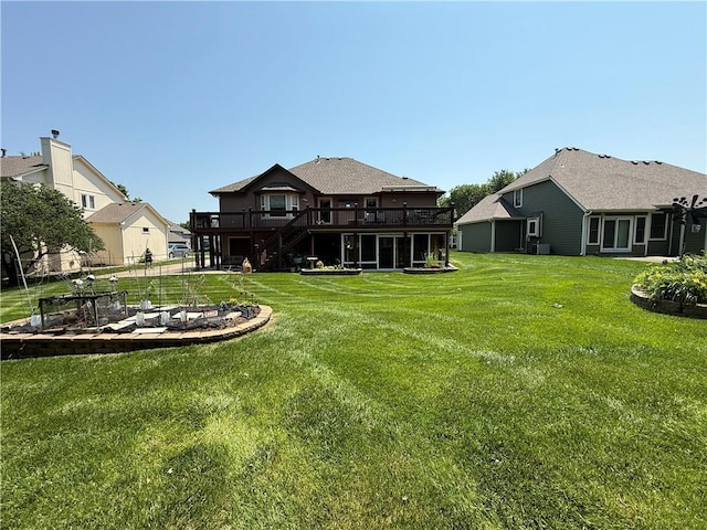 5118 SW Pelican Pt, Lees Summit, MO 64082 - view of green lawn with a wooden deck, stairs, and an outdoor fire pit