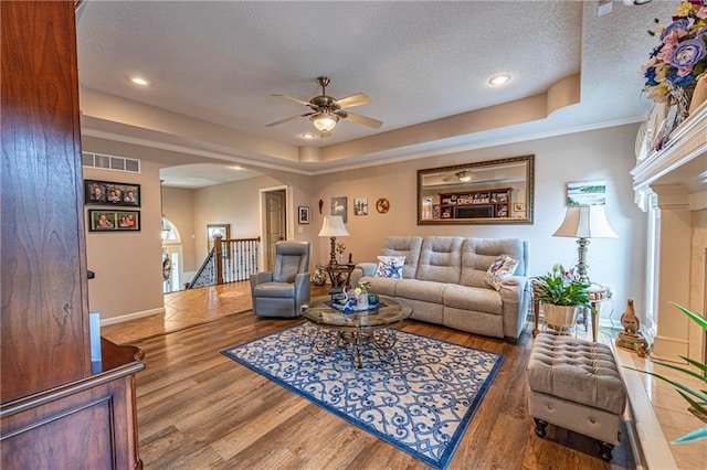 5118 SW Pelican Pt, Lees Summit, MO 64082 - living room featuring arched walkways, a ceiling fan, a textured ceiling, wood finished floors, and recessed lighting