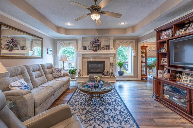 5118 SW Pelican Pt, Lees Summit, MO 64082 - living area with a textured ceiling, a raised ceiling, wood finished floors, and a ceiling fan