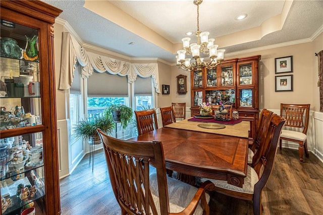 5118 SW Pelican Pt, Lees Summit, MO 64082 - dining space with a raised ceiling, a chandelier, dark wood-type flooring, crown molding, and wainscoting