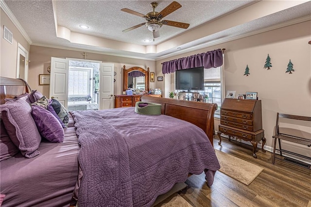 5118 SW Pelican Pt, Lees Summit, MO 64082 - bedroom with a textured ceiling, wood finished floors, crown molding, a tray ceiling, and ceiling fan
