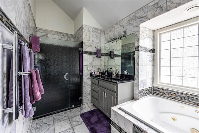 5118 SW Pelican Pt, Lees Summit, MO 64082 - bathroom featuring tile walls, vanity, lofted ceiling, marble finish floors, and a whirlpool tub