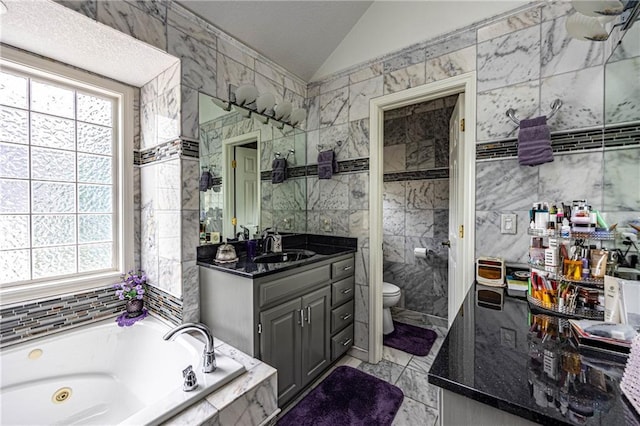 5118 SW Pelican Pt, Lees Summit, MO 64082 - bathroom with healthy amount of natural light, tile walls, a jetted tub, vanity, and lofted ceiling