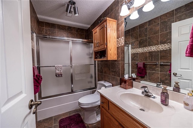 5118 SW Pelican Pt, Lees Summit, MO 64082 - full bath with tile walls, bath / shower combo with glass door, vanity, and a textured ceiling