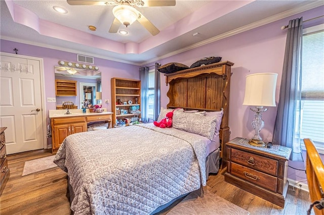 5118 SW Pelican Pt, Lees Summit, MO 64082 - bedroom with multiple windows, wood finished floors, and ornamental molding