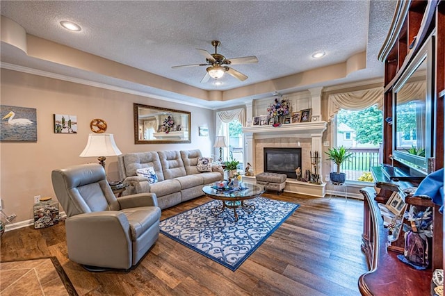 5118 SW Pelican Pt, Lees Summit, MO 64082 - living area with a textured ceiling, a ceiling fan, wood finished floors, a tiled fireplace, and recessed lighting