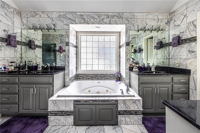 5118 SW Pelican Pt, Lees Summit, MO 64082 - bathroom featuring tile walls, two vanities, and a jetted tub