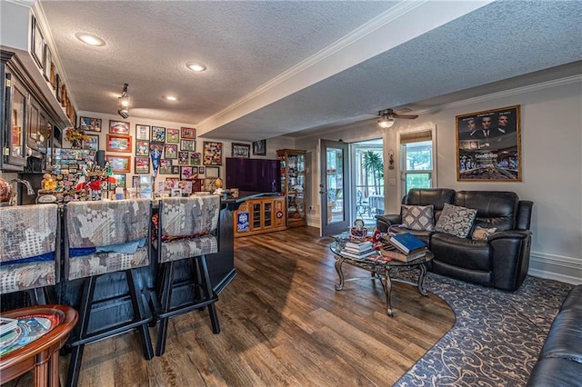 5118 SW Pelican Pt, Lees Summit, MO 64082 - living room with a textured ceiling, crown molding, dark wood-style floors, recessed lighting, and bar area