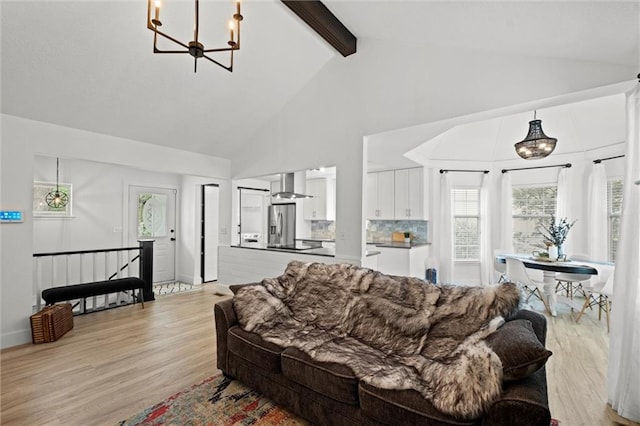 2421 NW Acorn Dr, Blue Springs, MO 64014 - living area with a chandelier, high vaulted ceiling, beam ceiling, and light wood finished floors