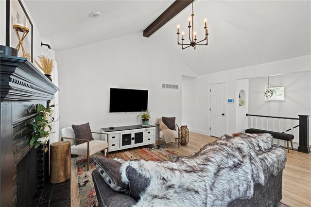 2421 NW Acorn Dr, Blue Springs, MO 64014 - living room featuring wood finished floors, a chandelier, beamed ceiling, and high vaulted ceiling
