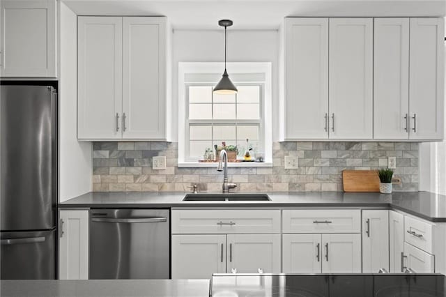 2421 NW Acorn Dr, Blue Springs, MO 64014 - kitchen featuring appliances with stainless steel finishes, white cabinetry, tasteful backsplash, and decorative light fixtures