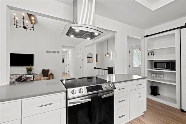 2421 NW Acorn Dr, Blue Springs, MO 64014 - kitchen featuring appliances with stainless steel finishes, island range hood, white cabinets, open floor plan, and a chandelier