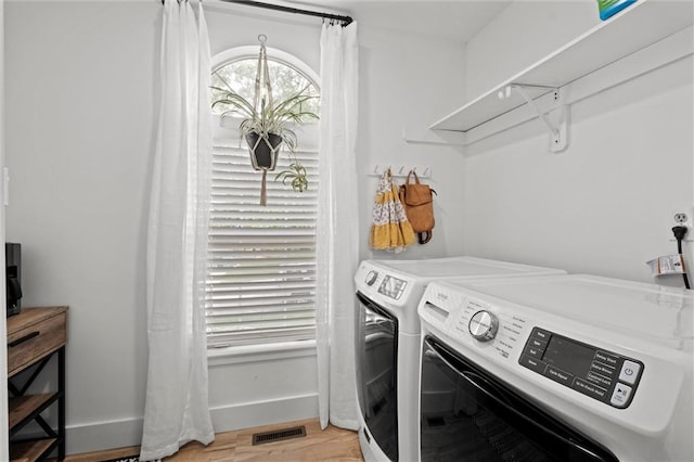 2421 NW Acorn Dr, Blue Springs, MO 64014 - washroom featuring washing machine and clothes dryer and light wood-style flooring