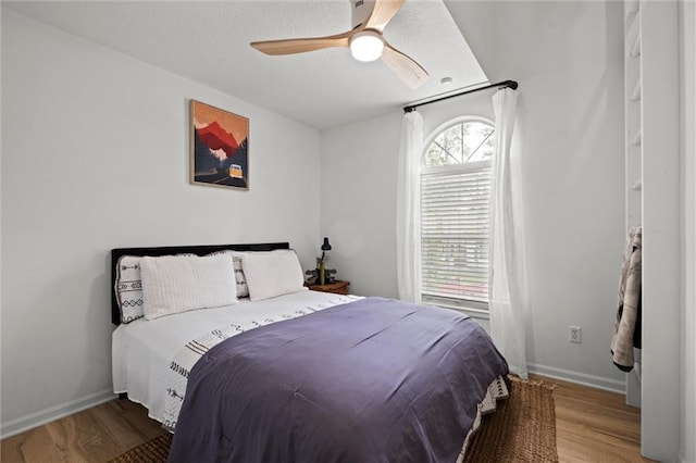 2421 NW Acorn Dr, Blue Springs, MO 64014 - bedroom featuring wood finished floors, ceiling fan, and a textured ceiling