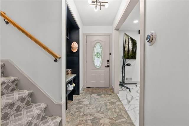 6101 E 107th St, Kansas City, MO 64134 - foyer entrance featuring stairway and light marble finish floors