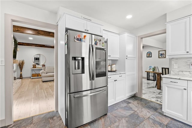 6101 E 107th St, Kansas City, MO 64134 - kitchen with stainless steel refrigerator with ice dispenser, white cabinetry, decorative backsplash, beam ceiling, and recessed lighting