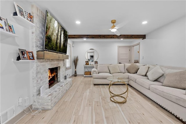 6101 E 107th St, Kansas City, MO 64134 - living area featuring beam ceiling, a ceiling fan, recessed lighting, a fireplace, and wood finished floors