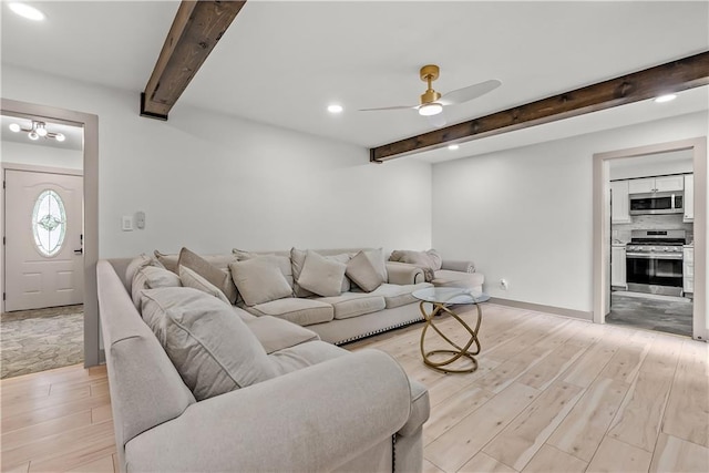 6101 E 107th St, Kansas City, MO 64134 - living room featuring beamed ceiling, light wood-style flooring, a ceiling fan, and recessed lighting