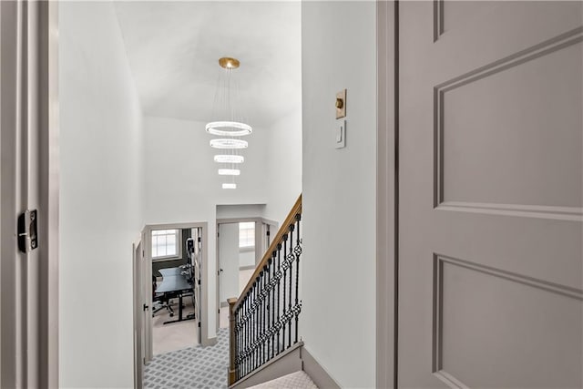 6101 E 107th St, Kansas City, MO 64134 - stairs with a chandelier, carpet, and a towering ceiling