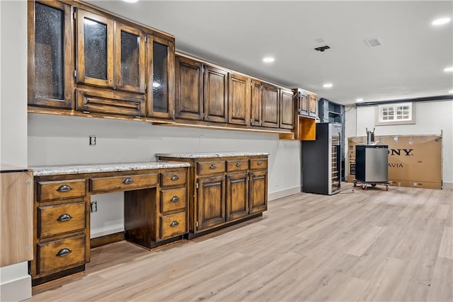 6101 E 107th St, Kansas City, MO 64134 - kitchen with light wood-style floors, recessed lighting, light stone countertops, an office area, and water heater