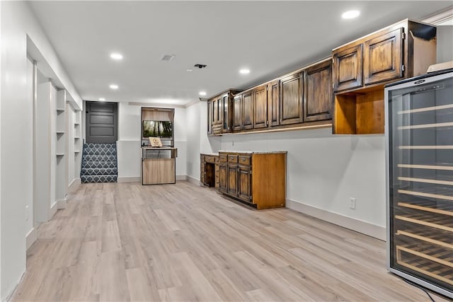 6101 E 107th St, Kansas City, MO 64134 - bar area with wine cooler, light wood-style flooring, and recessed lighting