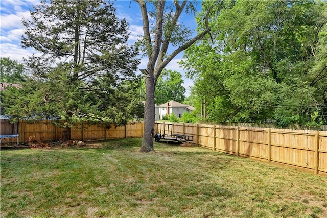 6101 E 107th St, Kansas City, MO 64134 - fenced backyard featuring a trampoline