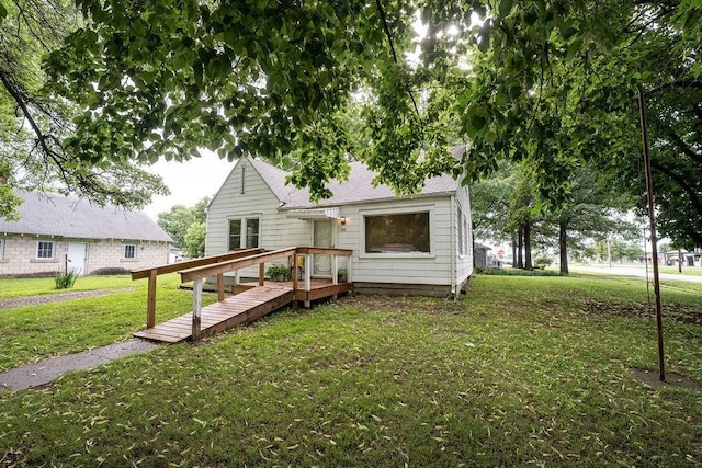 103 N Missouri St, Adrian, MO 64720 - back of house featuring a lawn, roof with shingles, and a wooden deck