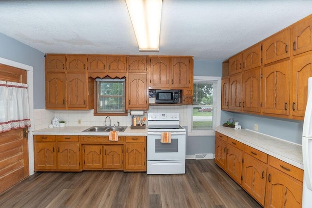 103 N Missouri St, Adrian, MO 64720 - kitchen with white appliances, brown cabinetry, light countertops, decorative backsplash, and dark wood-style floors