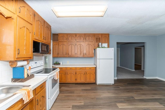 103 N Missouri St, Adrian, MO 64720 - kitchen featuring white appliances, light countertops, brown cabinets, dark wood finished floors, and backsplash