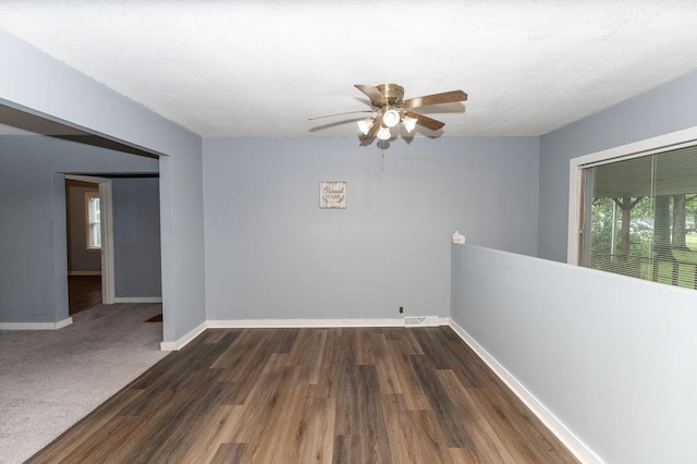 103 N Missouri St, Adrian, MO 64720 - spare room featuring a ceiling fan and dark wood-style flooring