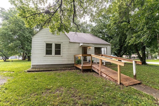 103 N Missouri St, Adrian, MO 64720 - view of front of house featuring a wooden deck, a front yard, a garage, and roof with shingles