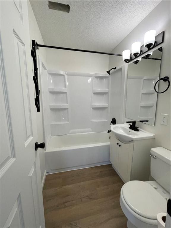 10818-10820 W 57th St, Shawnee, KS 66203 - full bath with a textured ceiling, vanity, wood finished floors, and washtub / shower combination