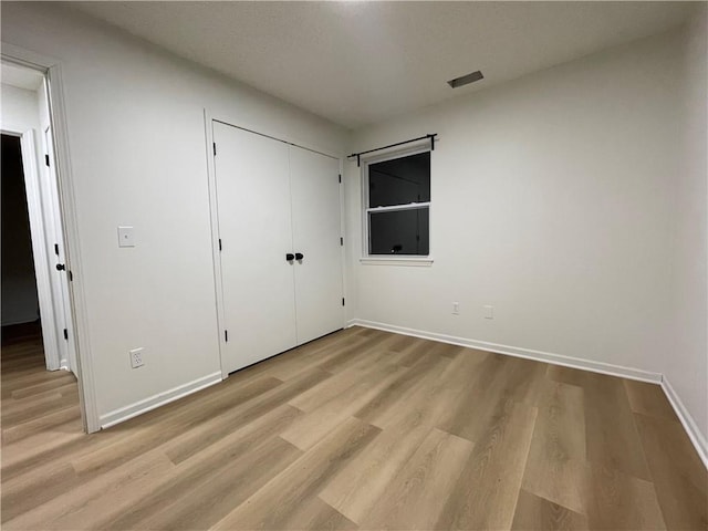 10818-10820 W 57th St, Shawnee, KS 66203 - unfurnished bedroom featuring wood finished floors and a closet