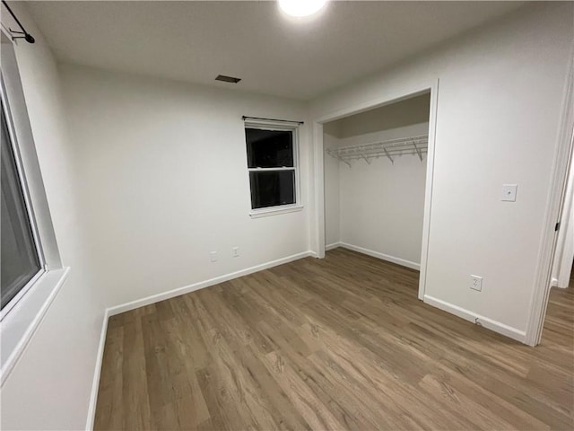 10818-10820 W 57th St, Shawnee, KS 66203 - unfurnished bedroom featuring light wood-style floors and a closet